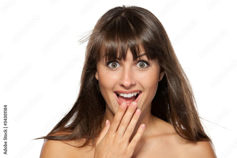 Surprised woman with hands over her mouth laughing Surprised woman with hands over her mouth laughing