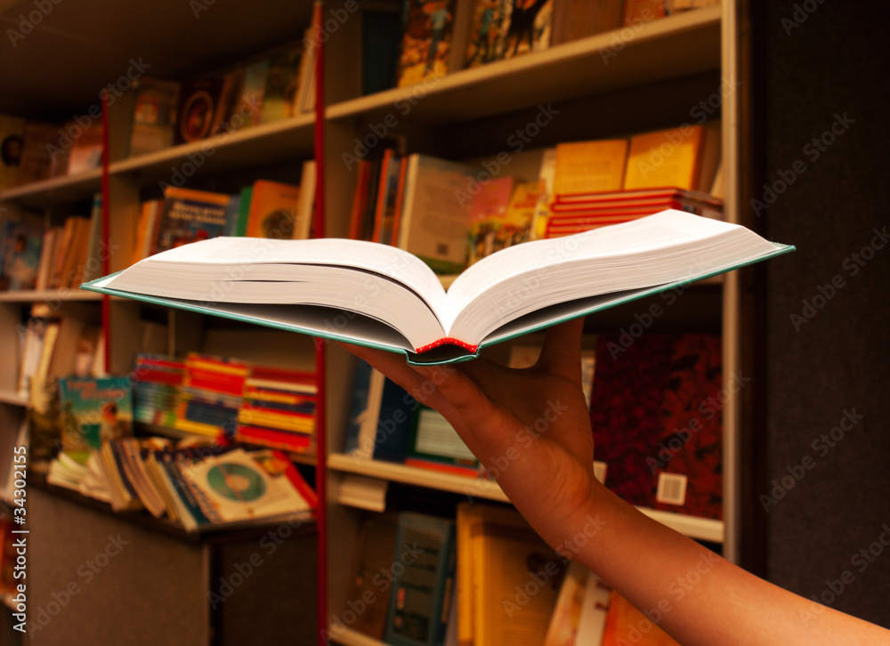 Hand holding open book
