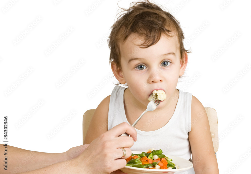 Little boy tasting vegetable salad Little boy tasting vegetable salad