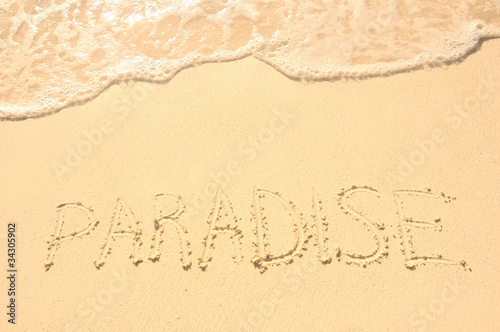 Paradise Written in Sand on Beach