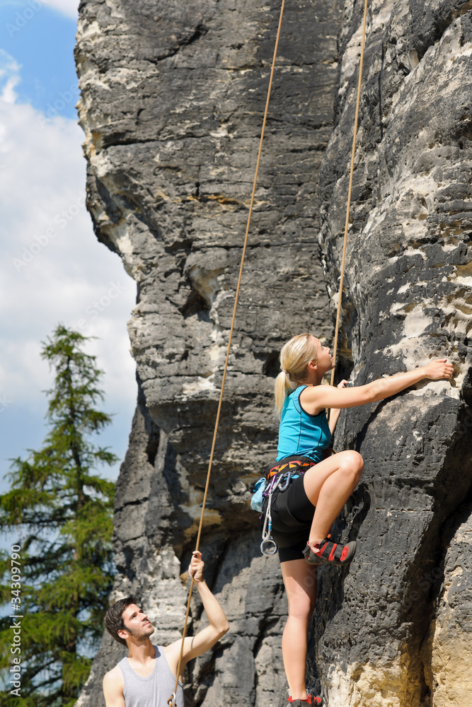 Rock climbing male instructor blond woman sunny