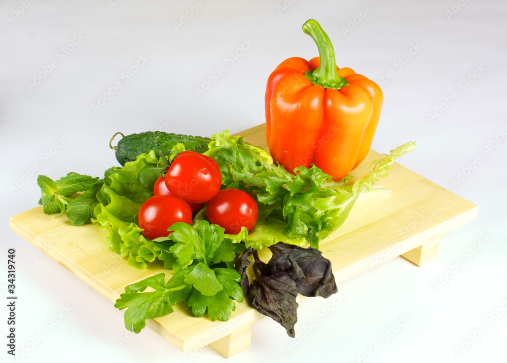 fresh and juicy vegetables on the wood plate isolated