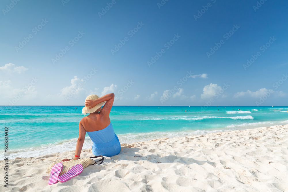 Woman in hat relaxing on holiday at Caribbean Sea Woman in hat relaxing on holiday at Caribbean Sea