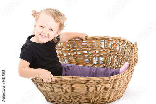 Beautiful little girl in basket