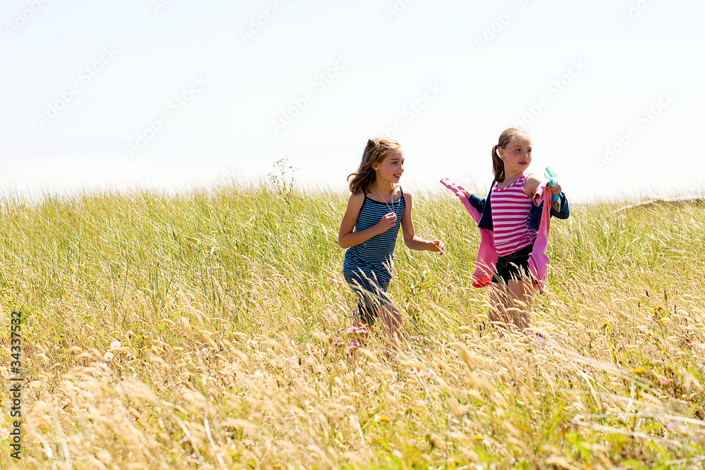 Children running in a grassy field. Children running in a grassy field.
