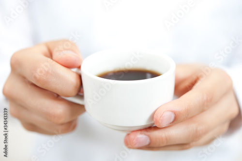 a woman drinkig a cup of coffee