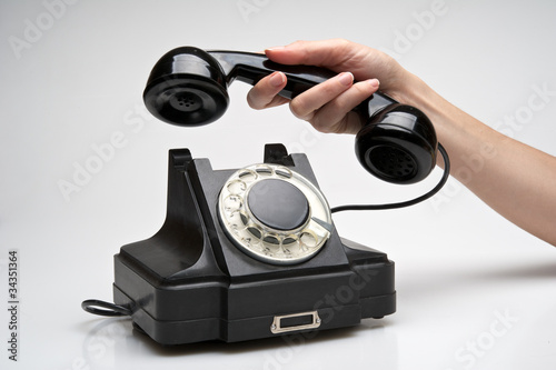 Vintage telephone being picked up