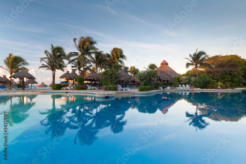 Tropical swimming pool at sunrise in Mexico