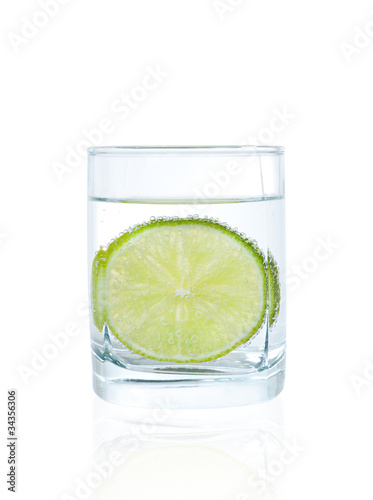 Slice of lime in glass of mineral water