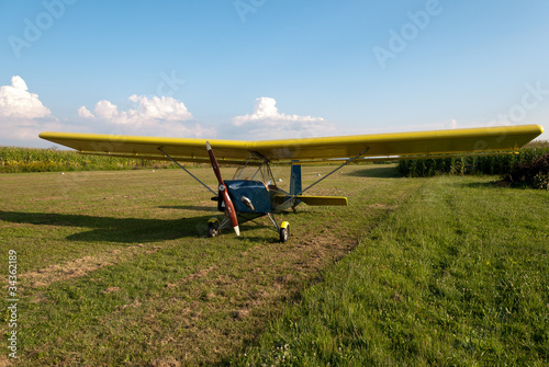 Small microlight aircarft parked in an airfield.