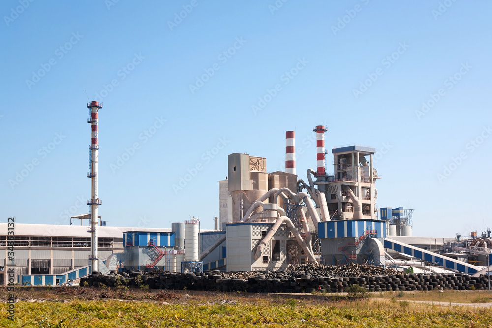 Rubber factory integrated into the landscape against blue sky Rubber factory integrated into the landscape against blue sky