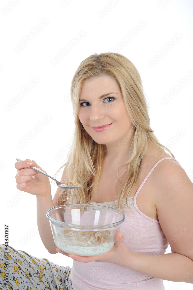 beautiful female having muesli cereals for breakfast. isolated o beautiful female having muesli cereals for breakfast. isolated o