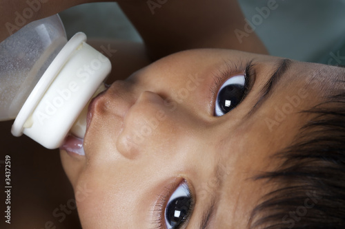 Adorable Indian baby being fed