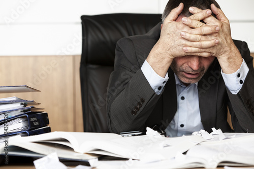 Frustrated office manager overloaded with work. photo