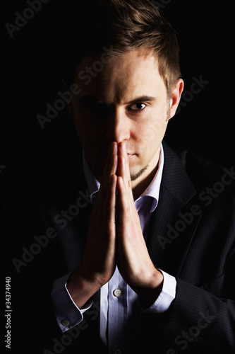 Portrait of businessman with folded hands.