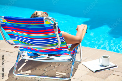 The woman relaxing near the pool