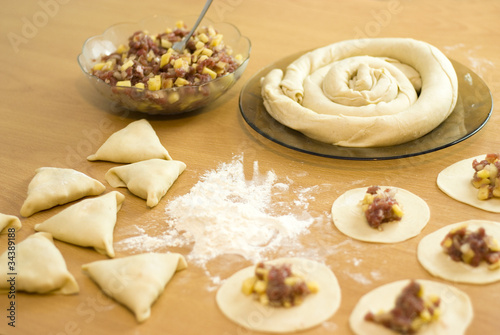 dough with minced meat patties cooking Asian samsa