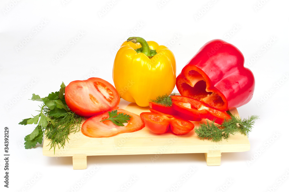 Pepper, tomato with dill and parsley on the wood desk isolated Pepper, tomato with dill and parsley on the wood desk isolated