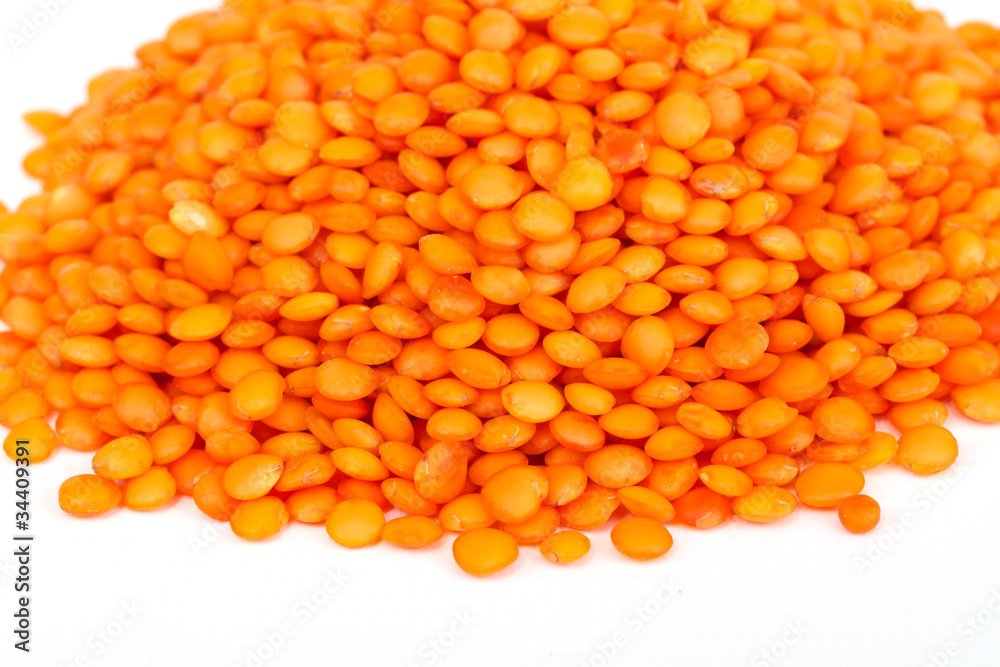 Heap of raw red lentils isolated on white background