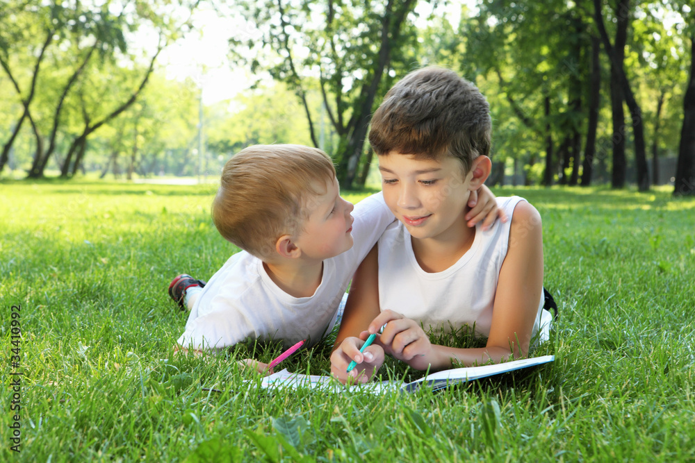 Children in the park reading a book Children in the park reading a book