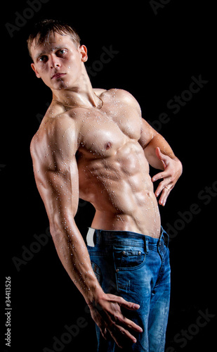 Muscle sexy young man perfused with milk photo