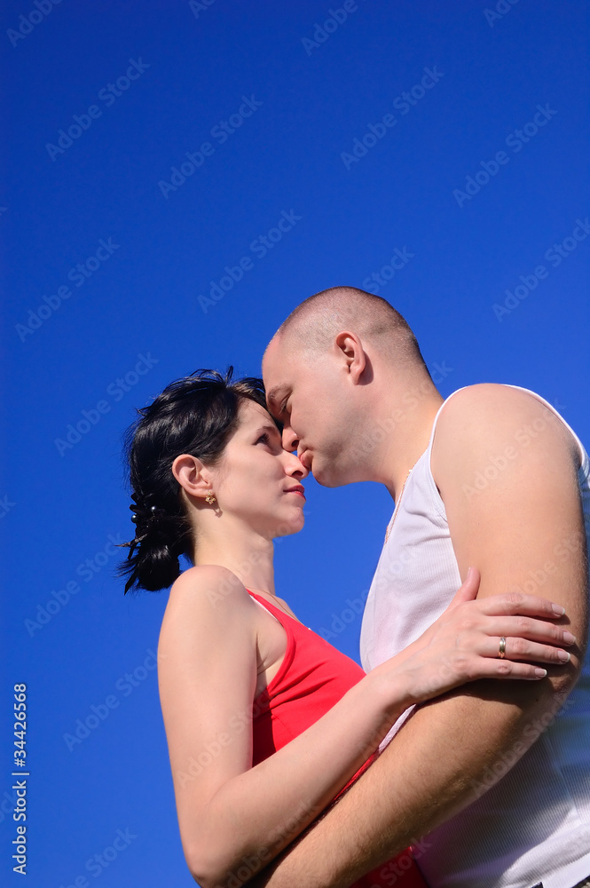 Loving couple kissing in the sky