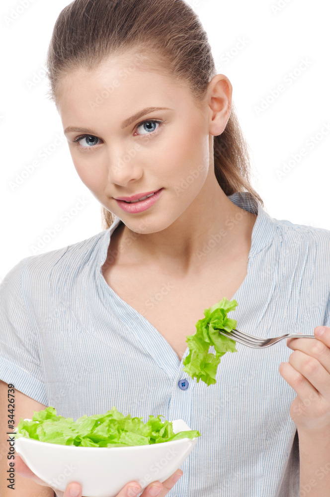 Pretty young woman eating lettuce salad. Isolated Pretty young woman eating lettuce salad. Isolated