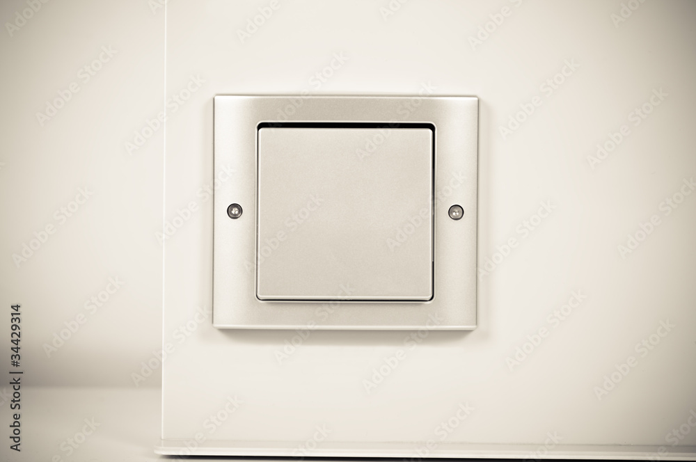 light switch on the wall in sepia light switch on the wall in sepia