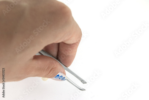 A woman hand with a tweezer