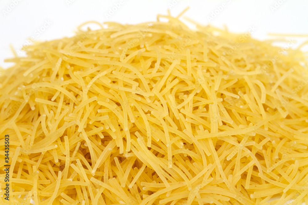 close up of a dried italian pasta on white background close up of a dried italian pasta on white background