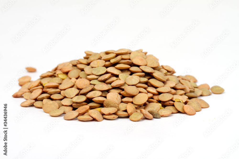 Pile of green lentils from low perspective isolated on white. Pile of green lentils from low perspective isolated on white.