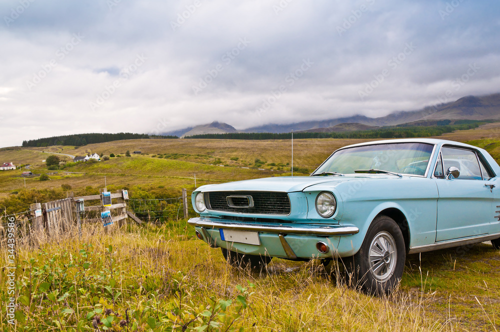 Old car on scottish countryside panorama Old car on scottish countryside panorama