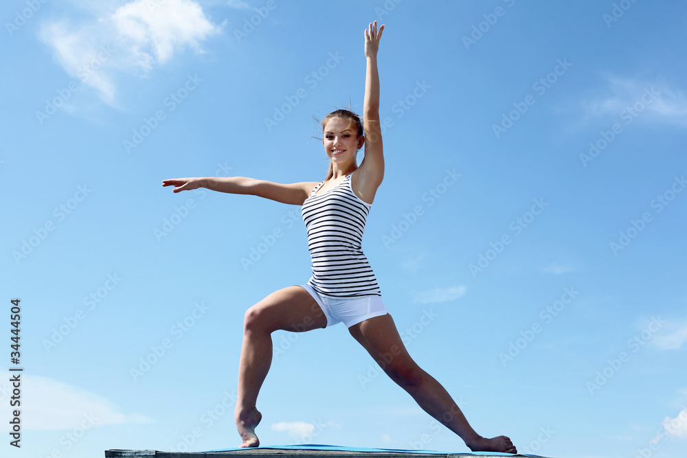 Fototapeta premium Portrait of a young woman doing exercises