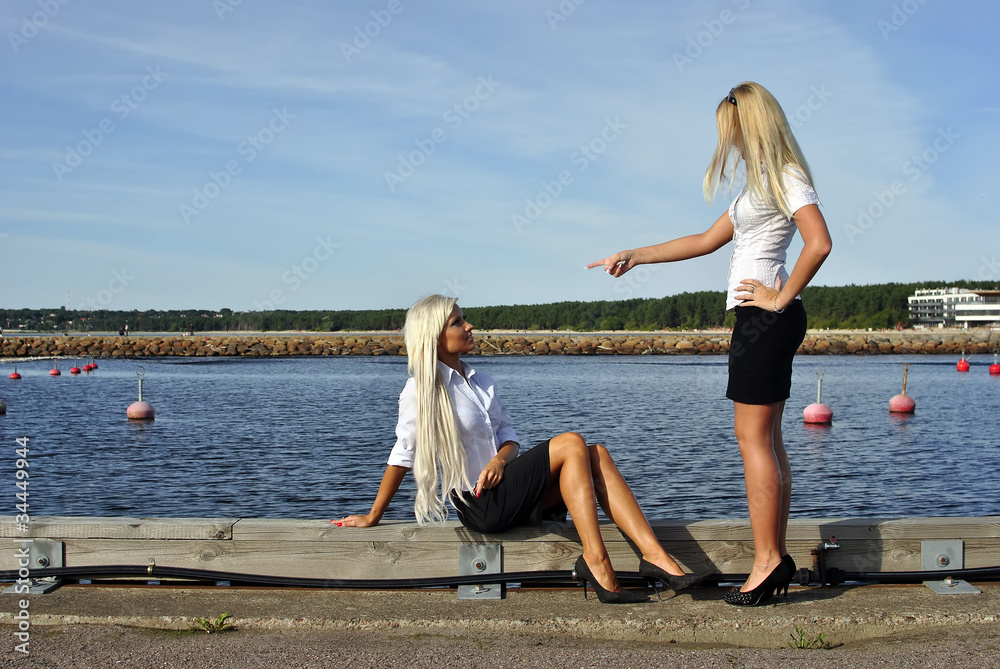 Girl arguing with another girl on the pier
