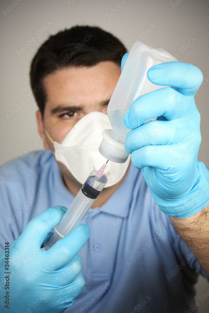 Adult man with syringe and bottle Adult man with syringe and bottle