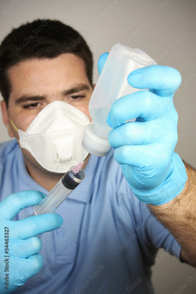 Adult man with syringe and bottle Adult man with syringe and bottle