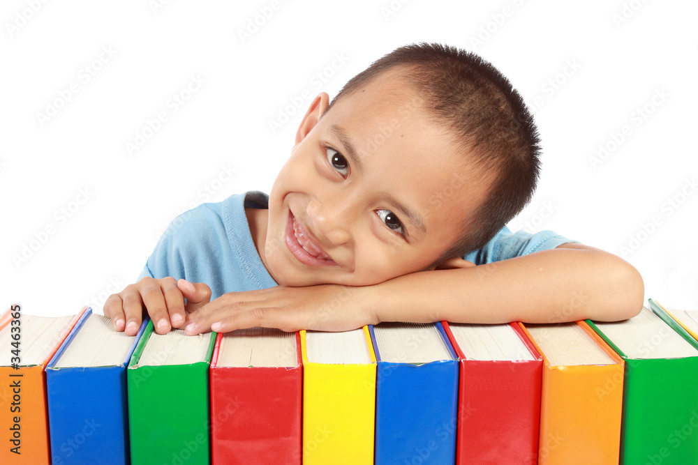 portrait of young boy leaning on top of his colorful books portrait of young boy leaning on top of his colorful books