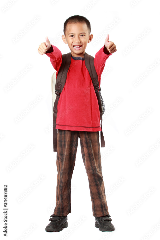 Portrait of boy with backpack smiling showing thumb up sign agai Portrait of boy with backpack smiling showing thumb up sign agai