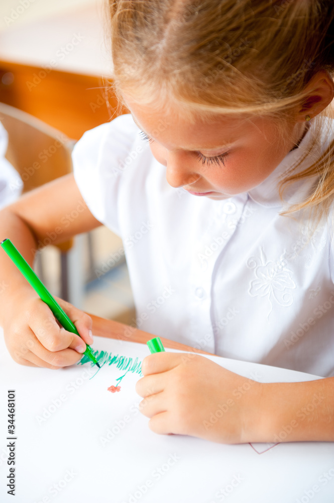 Little girl looking for a drawing concept wile painting picture