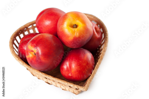 peaches on a white background in the basket
