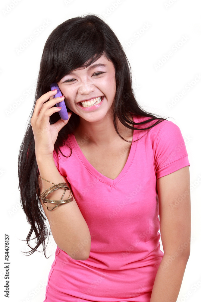 Attractive woman on the phone laughing isolated over white Attractive woman on the phone laughing isolated over white