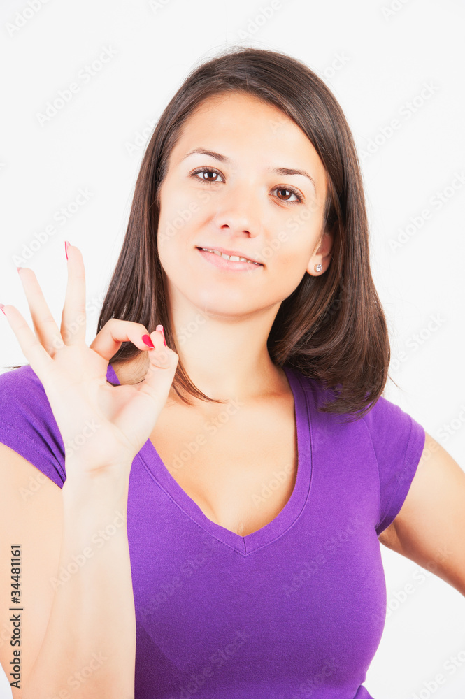 Closeup of lovely young woman gesturing ok hand sign Closeup of lovely young woman gesturing ok hand sign