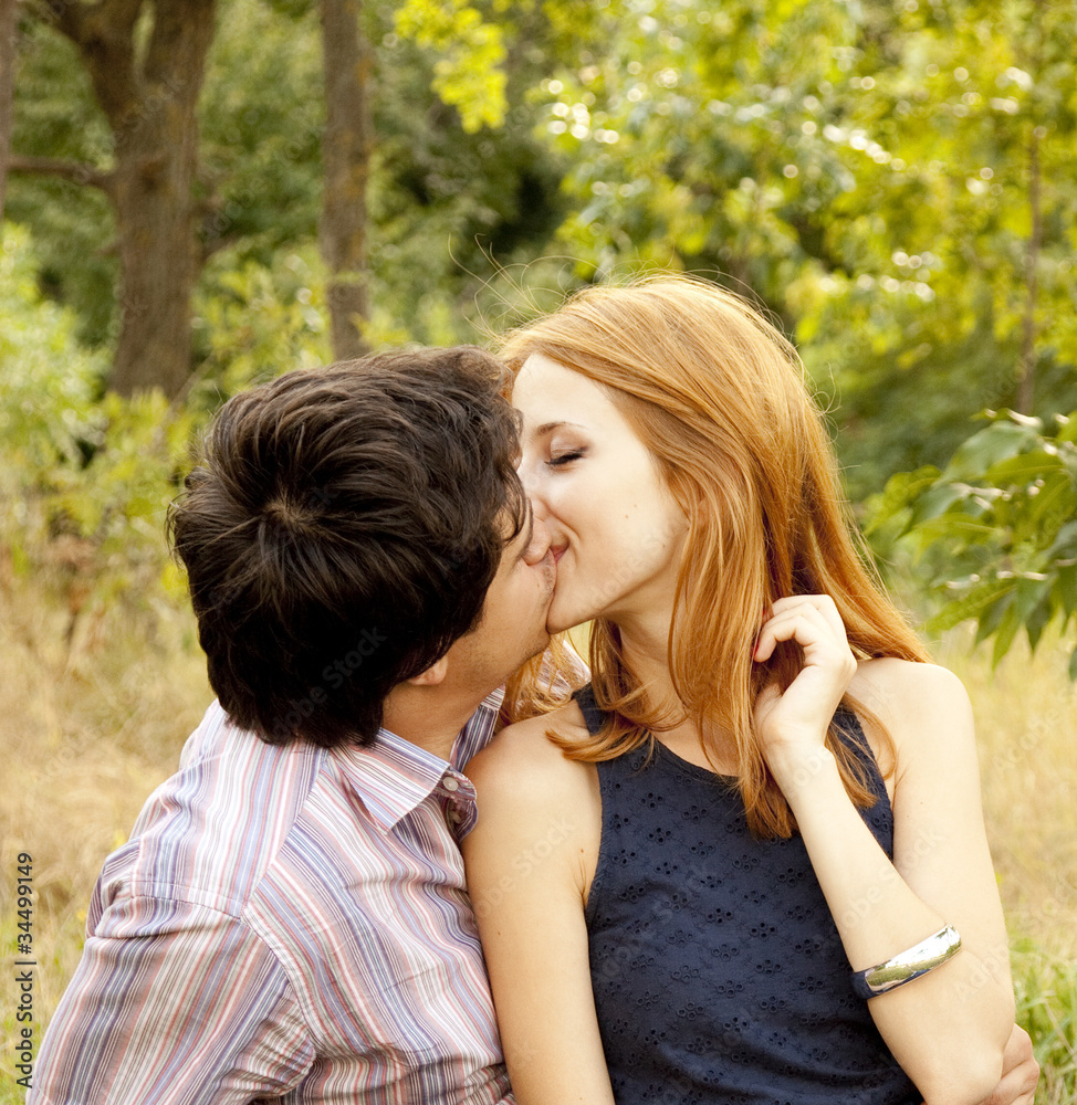 Young couple in love kissing outdoors. Young couple in love kissing outdoors.