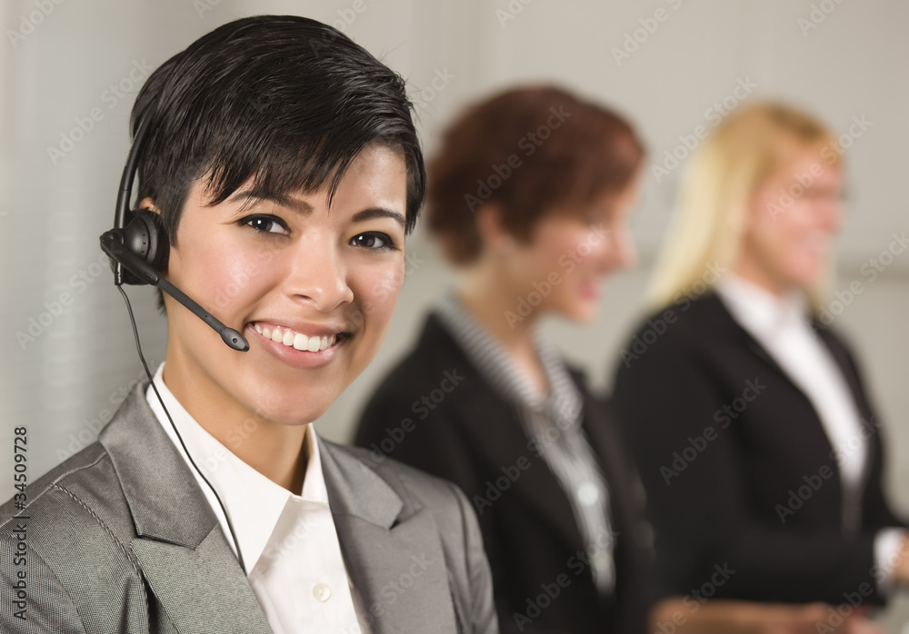 Pretty Hispanic Businesswoman with Colleagues Behind Pretty Hispanic Businesswoman with Colleagues Behind