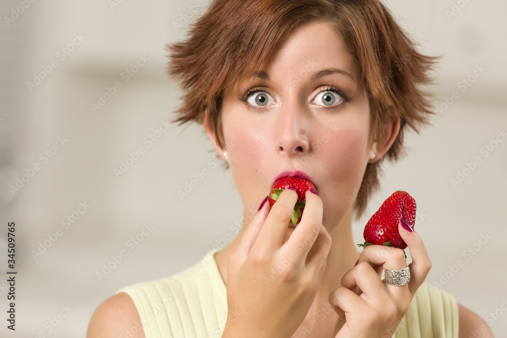Pretty Wide-eyed Red Haired Woman Biting Strawberry Pretty Wide-eyed Red Haired Woman Biting Strawberry