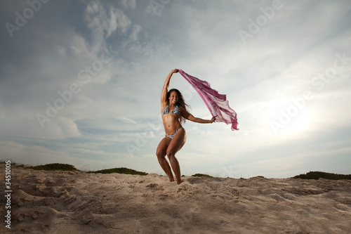 Young Brunette Woman at the beach enjoying herself