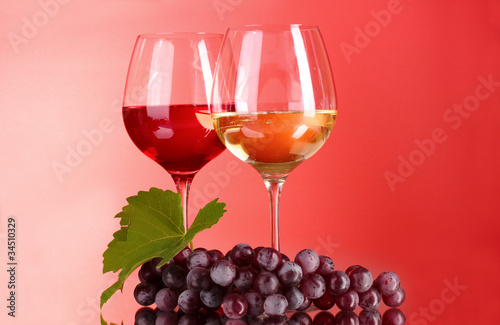 Wine bottle and glass on red background