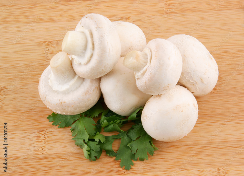 Fresh mushrooms and parsley on wooden background Fresh mushrooms and parsley on wooden background