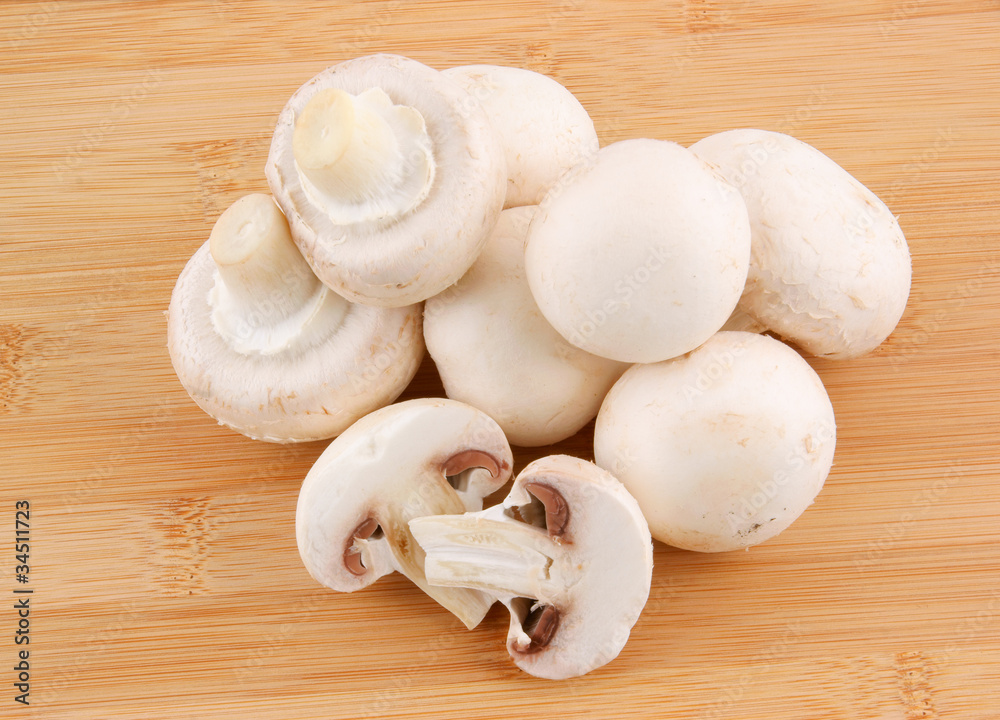 Fresh mushrooms champignon on wooden background Fresh mushrooms champignon on wooden background