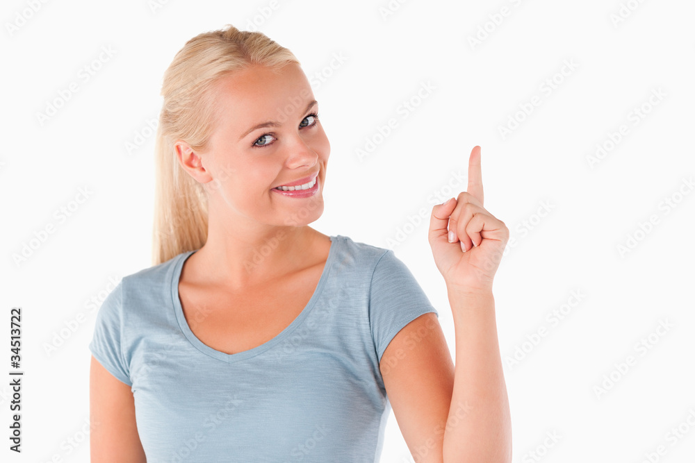 Woman pointing at copyspace looking into the camera Woman pointing at copyspace looking into the camera